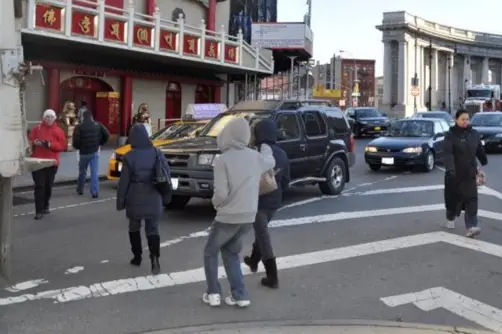 Pedestrians on the Chinatown side of Manhattan Bridge put their faith in Lady Luck